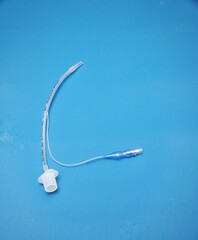 A pediatric endotracheal tube isolated on blue background