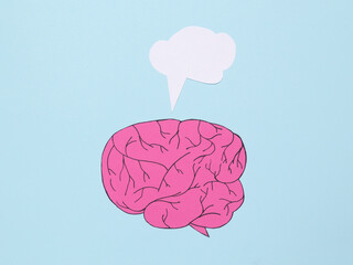 Paper cut human brain with blank dialog cloud on blue background