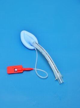 An adult laryngeal mask airway (LMA). Image isolated on blue background.