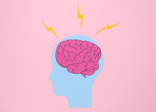 Paper cut human head with brain and arrows on pink background. Headache, brainstorming or flow of ideas concept