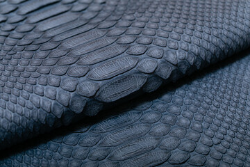 blue grey dyed genuine natural python leather on the wooden table	