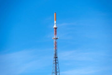 telecommunication tower with antennas on a blue sky