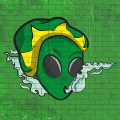 Graffitti about an Alien smoking some weed using rasta beret made in a green wall 