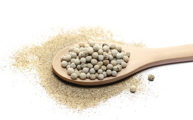 Milled and grain white pepper powder pile, peppercorn isolated on white  