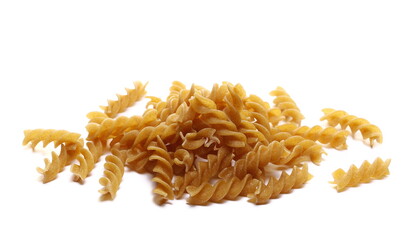 Pile wholemeal, uncooked integral pasta spirali isolated on white 