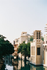 Fototapeta na wymiar buildings and trees along the Dubai River on a sunny day