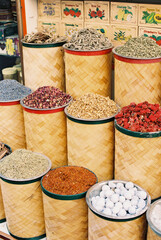 spices and loose leaf tea in baskets at outdoor market