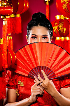 beautiful Thai woman posing in front of Chinese themed background