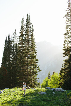 girl walking in sunlight in the Utah's big cottonwood canyon