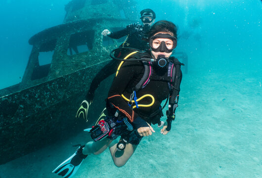 divers exploring a wreck on a dive around Phuket