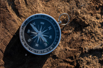 Fototapeta na wymiar Close up shot of a silver metal compass always pointing it's needle towards North