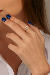 Golden Ring on a female hand, diamonds Diamond ring in hands of young lady. Close-up photo shoot