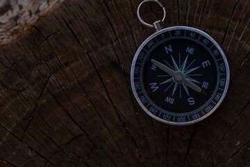 Fototapeta na wymiar Close up shot of a silver metal compass always pointing it's needle towards North