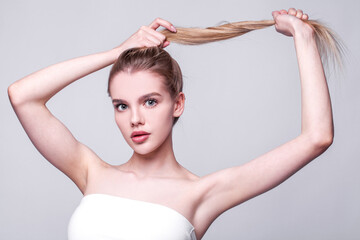 Close up portrait of a young beautiful girl isolated on gray background