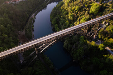 San Michele bridge over Adda river aerial view at sunset with no cars.