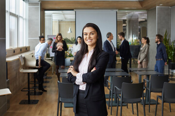 Portrait of happy smiling business teacher and professional team coach. Beautiful woman in suit...