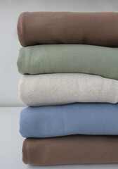 Neatly folded pastel hoodies. fabric texture close-up