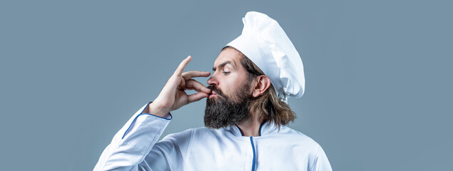 Professional chef man showing sign for delicious. Chef, cook making tasty delicious gesture by...