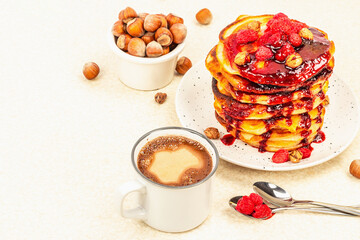 Traditional homemade breakfast with pancakes and coffee. Raspberry, hazelnut, sweet jam