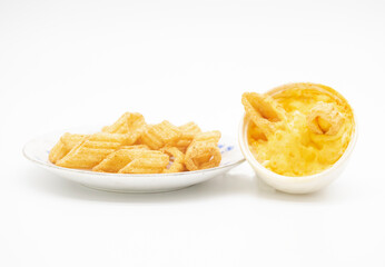 corn chips in a plate with white souce isolated on white background, selective focus