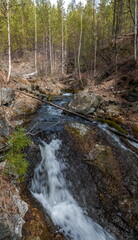 A mountain river flowing over rocks in spring