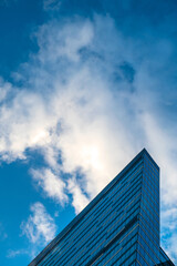 Obraz na płótnie Canvas Blue Skyscraper: The glass facade of a modern skyscraper seems to mimic the color of the sky at blue hour