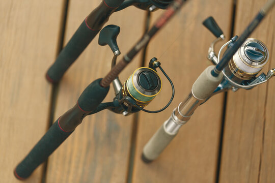 Fishing poles on cabin wood deck. Group of fishing poles and reels. 