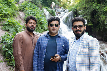 A group of visitors at waterfall 
