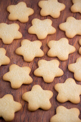 Cookies with sugar in the shape of an asterisk. A lot of Christmas cookies are lying and sprinkled with sugar