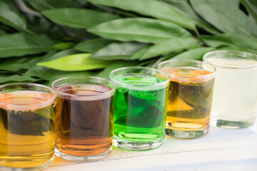 Bright colorful sweet drinks. Soda and cocktails in glasses are in a row
