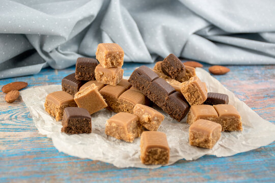 Chocolate caramel lies beautifully in pieces. Sweet toffee with nuts and cocoa