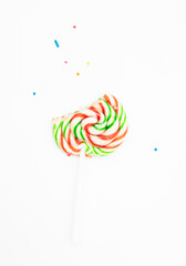 Colorful candy with sprinkles on a white background. Lollipop. Top view