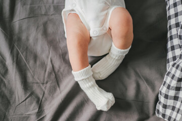 Close up of newborn feet. Soft focus. Grey and white colors.