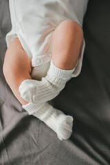 Close up of newborn feet. Soft focus. Grey and white colors.