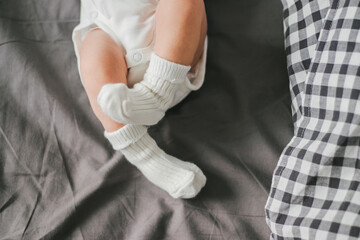 Close up of newborn feet. Soft focus. Grey and white colors.