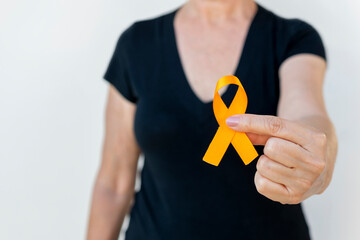 woman holding orange ribbon. campaign to prevent skin cancer, melanoma,