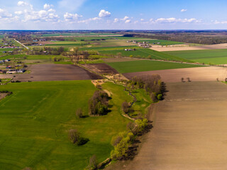 Naklejka premium Spring fields, meadows and villages seen from a bird's eye view on a sunny, clear day. Spring.