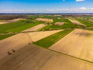 Spring fields, meadows and villages seen from a bird's eye view on a sunny, clear day. Spring.