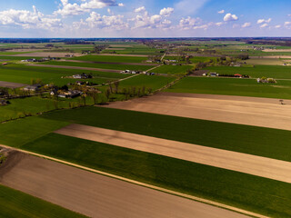 Spring fields, meadows and villages seen from a bird's eye view on a sunny, clear day. Spring.