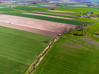 Spring fields, meadows and villages seen from a bird's eye view on a sunny, clear day. Spring.