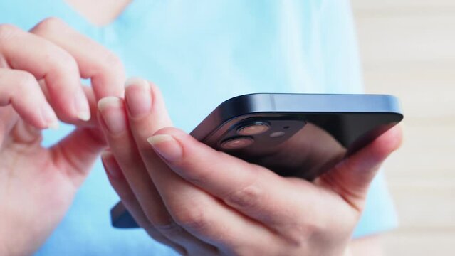 female hands use iPhone 12