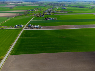 Obraz premium Spring fields, meadows and villages seen from a bird's eye view on a sunny, clear day. Spring.