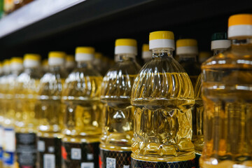 A lot of yellow sunflower oil bottles on the shelves in the supermarket. Sunflower oil shortage crisis in Europe.