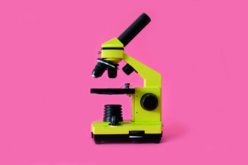 Microscope on a bright pink background. High quality photo.