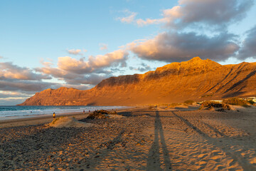 Famara beach and Risco de Famara mountains at sunset, Spain