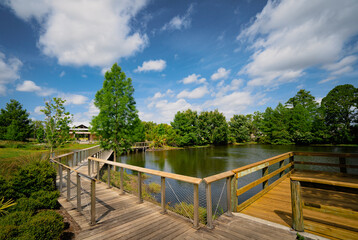 Fototapeta na wymiar Boardwalk over lake at Reiter community park in Longwood, a suburb of Orlando in Florida