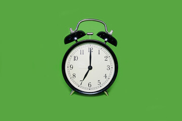 Clock alarm clock on a bright green background