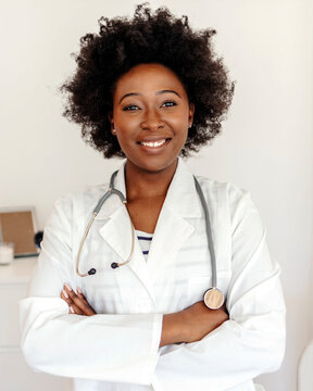 Portrait of a young doctor working in a clinic. Confident young doctor working in a modern hospital. Medical concept of young beautiful female doctor in white coat with phonendoscope, waist up.