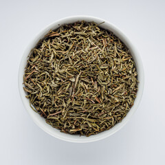fragrant dried thyme on a white acrylic background