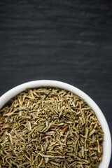 fragrant dried thyme on a dark stone background